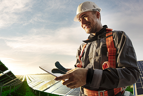 2 Photographie d'un ouvrier au milieu d'une installation de panneaux photovoltaïque pour évoquer la problématique de la réduction de son empreinte écologique